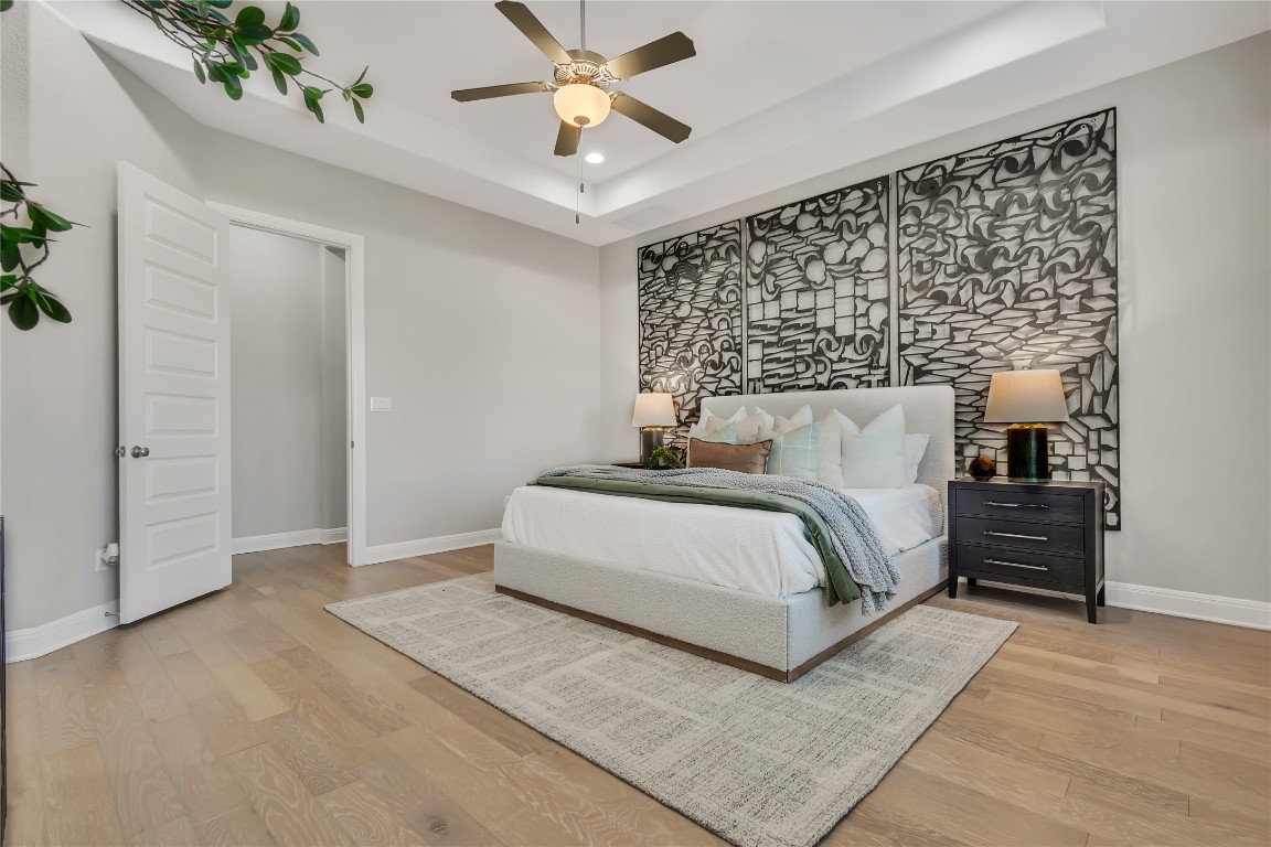 1700 Jackpot Run Leander, TX 78641 - Photo 20 of 40 a bedroom with a bed and a chandelier