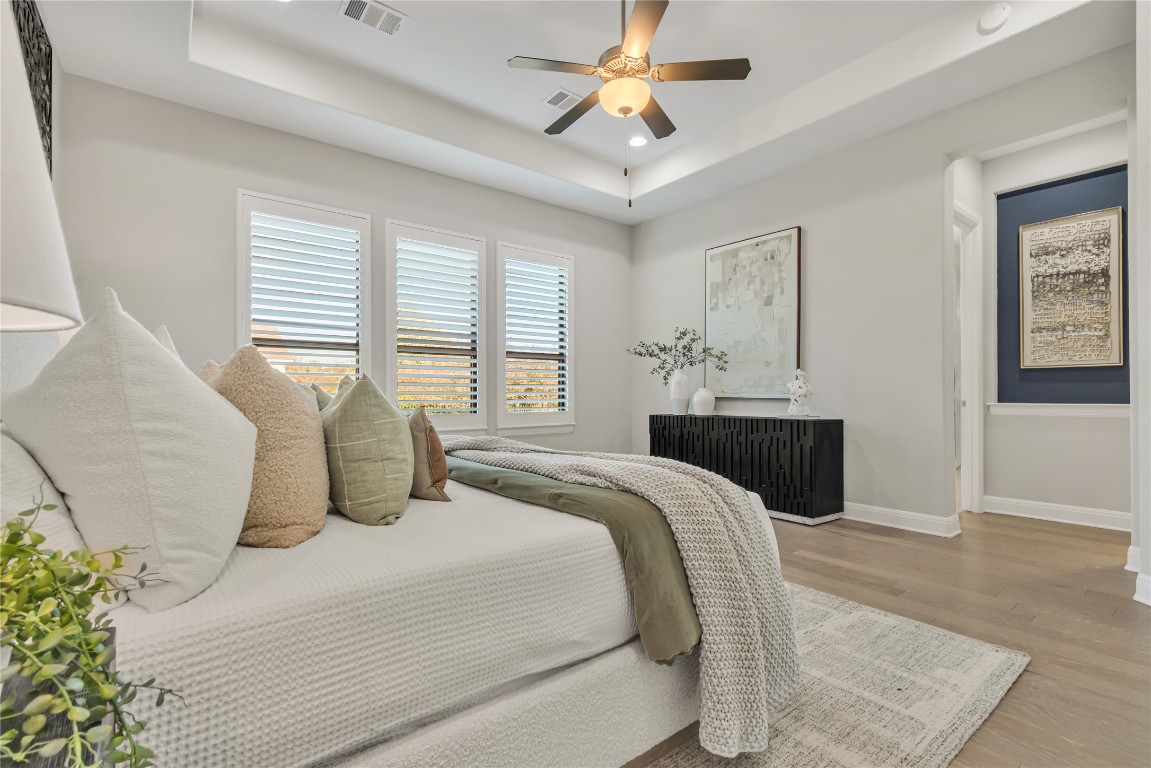 1700 Jackpot Run Leander, TX 78641 - Photo 21 of 40 a bedroom with a bed and a chandelier