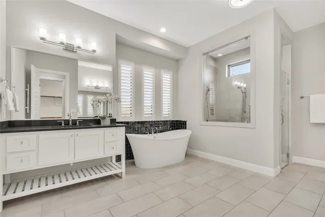 a bathroom with a sink a mirror and a bathtub