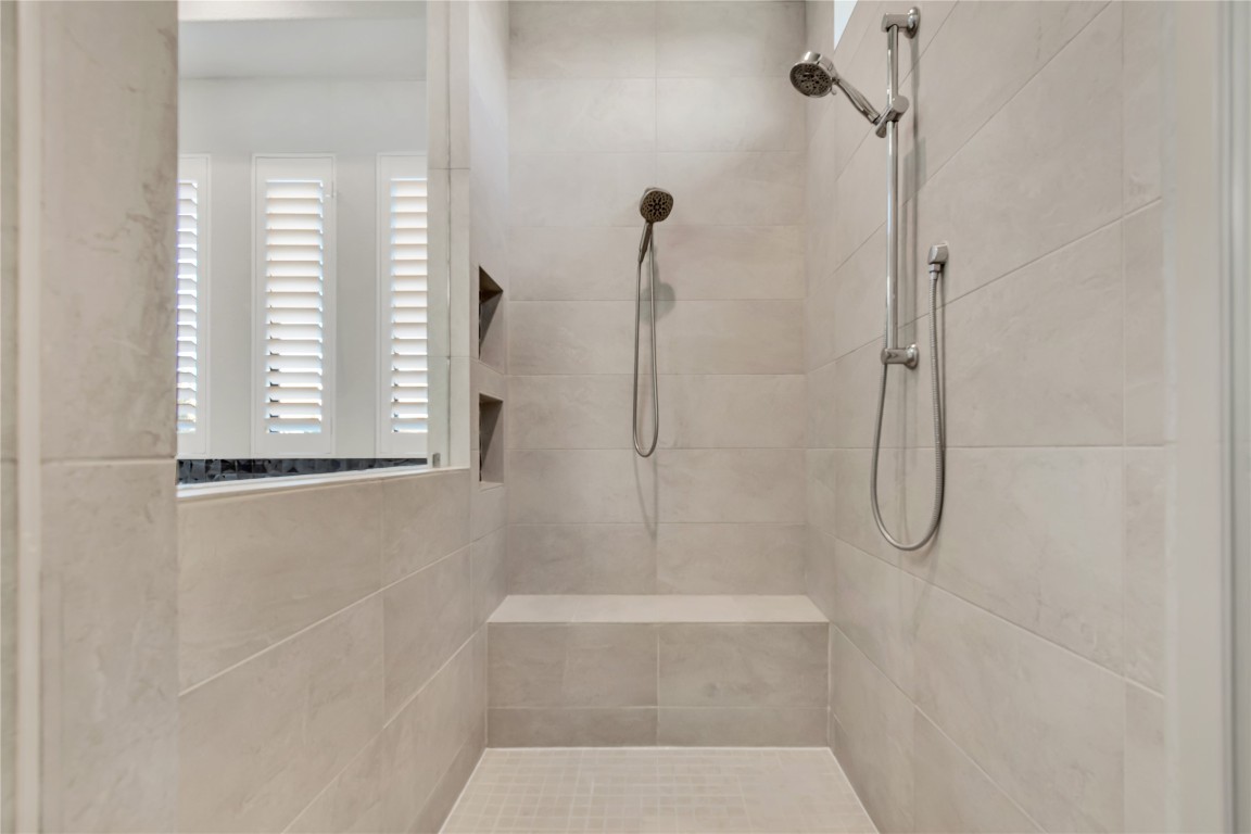 1700 Jackpot Run Leander, TX 78641 - Photo 25 of 40 a bathroom with a bath tub with a shower