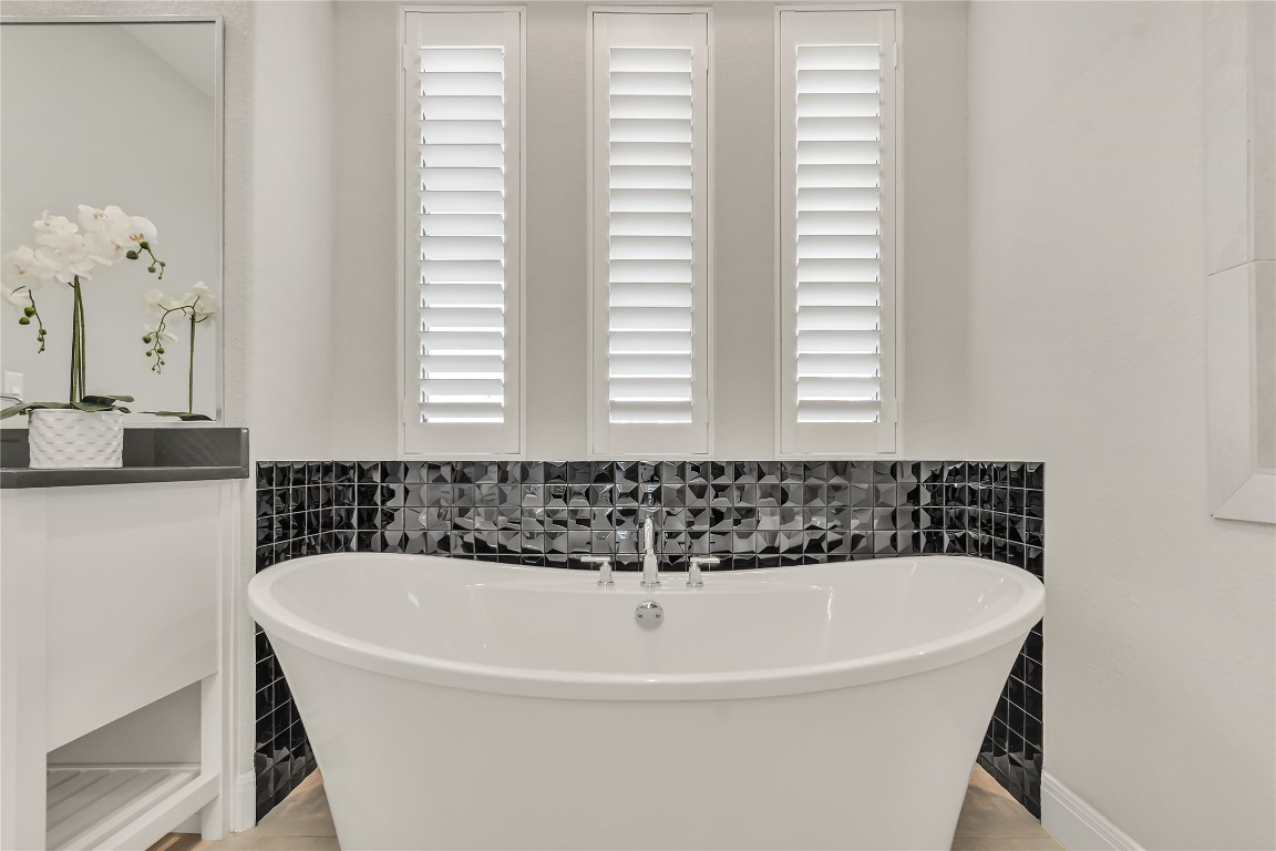 1700 Jackpot Run Leander, TX 78641 - Photo 26 of 40 a white bath tub sitting in a bathroom