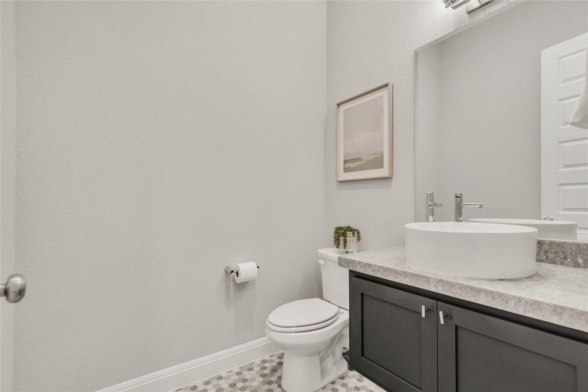 1700 Jackpot Run Leander, TX 78641 - Photo 30 of 40 a bathroom with a toilet a sink and mirror