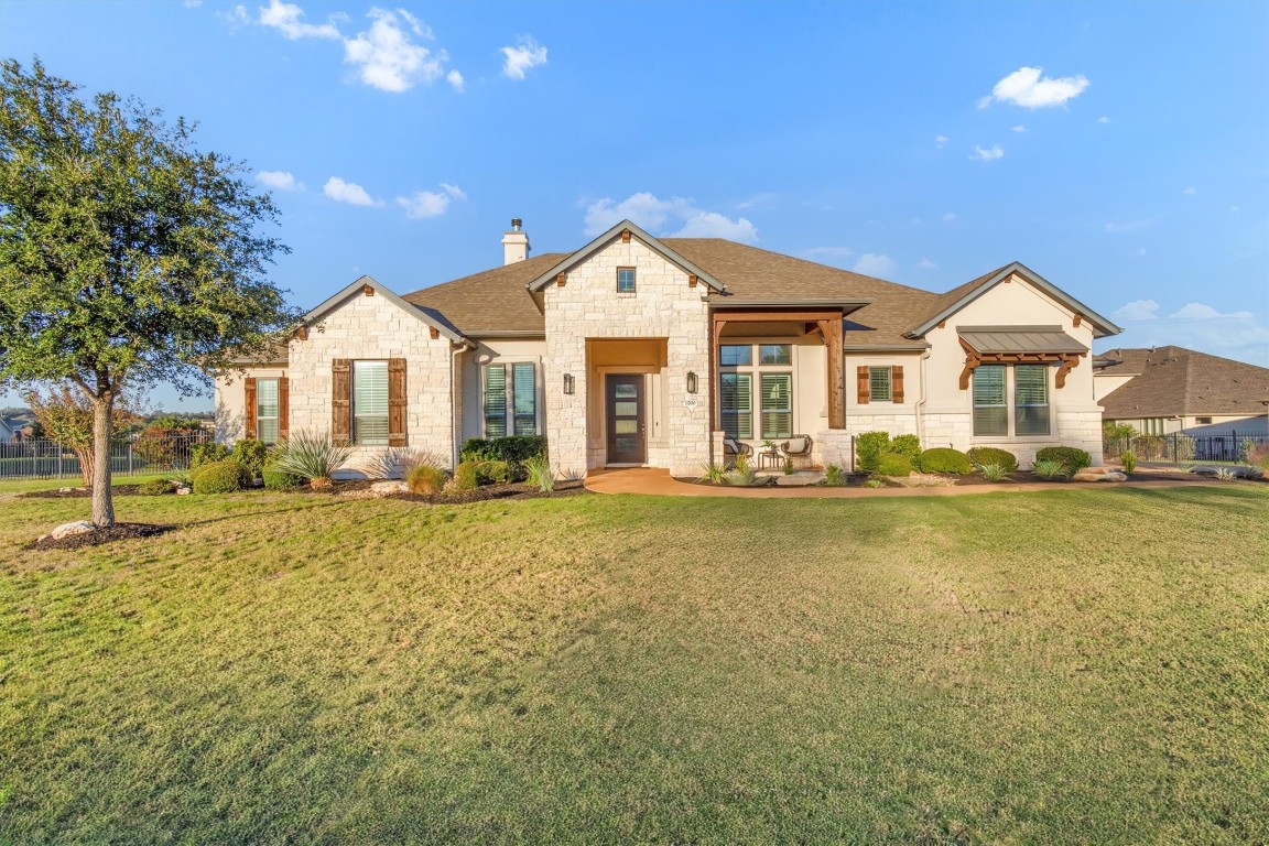 1700 Jackpot Run Leander, TX 78641 - Photo 3 of 40 a front view of a house with a yard outdoor seating and garage