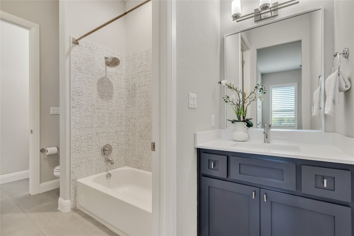 1700 Jackpot Run Leander, TX 78641 - Photo 35 of 40 a bathroom with a tub a sink and mirror