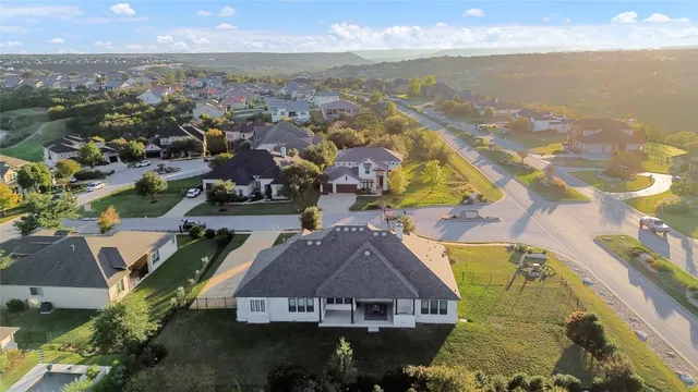 an aerial view of a residential houses with outdoor space