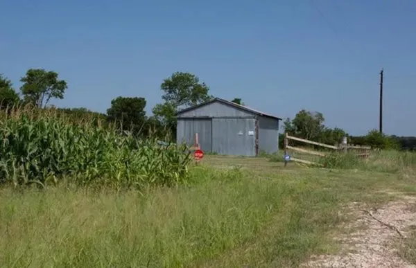 a view of outdoor space with green field and trees around