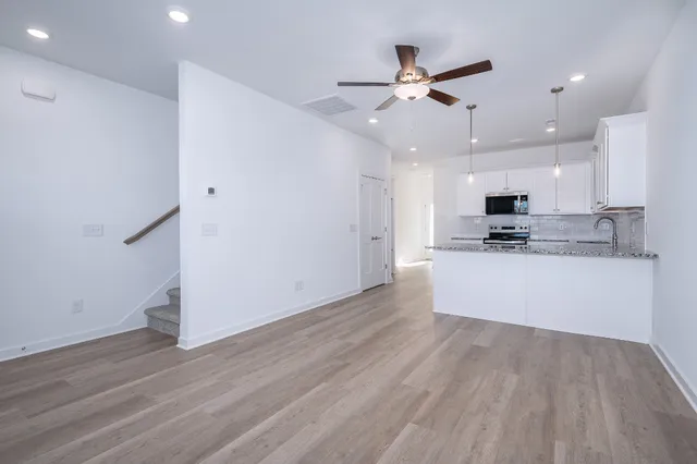 a view of kitchen with refrigerator microwave and stove