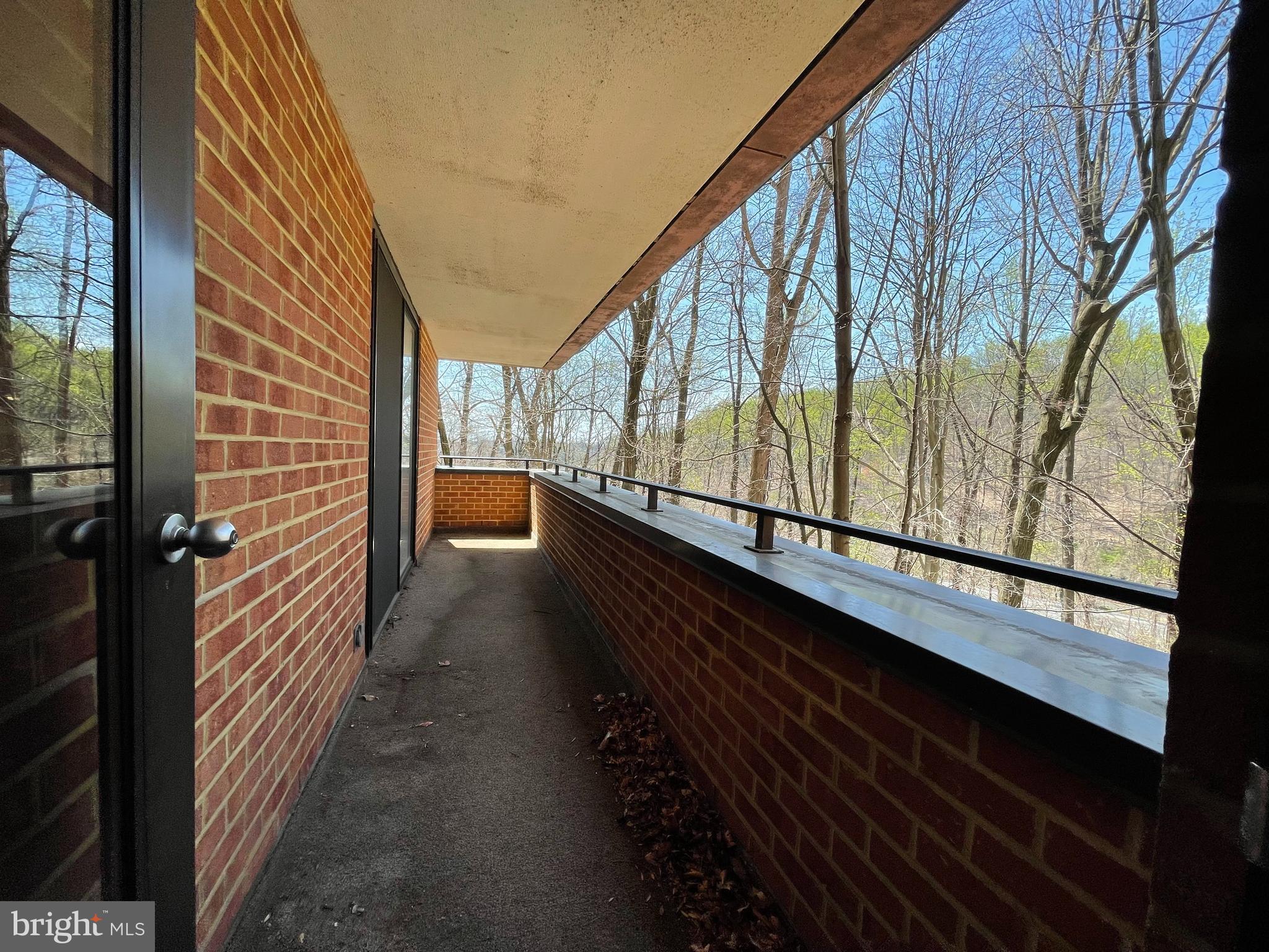 111 Hamlet Hill Road, Unit 413 Baltimore, MD 21210 - Photo 34 of 50 Balcony opens to living room and primary bedroom.