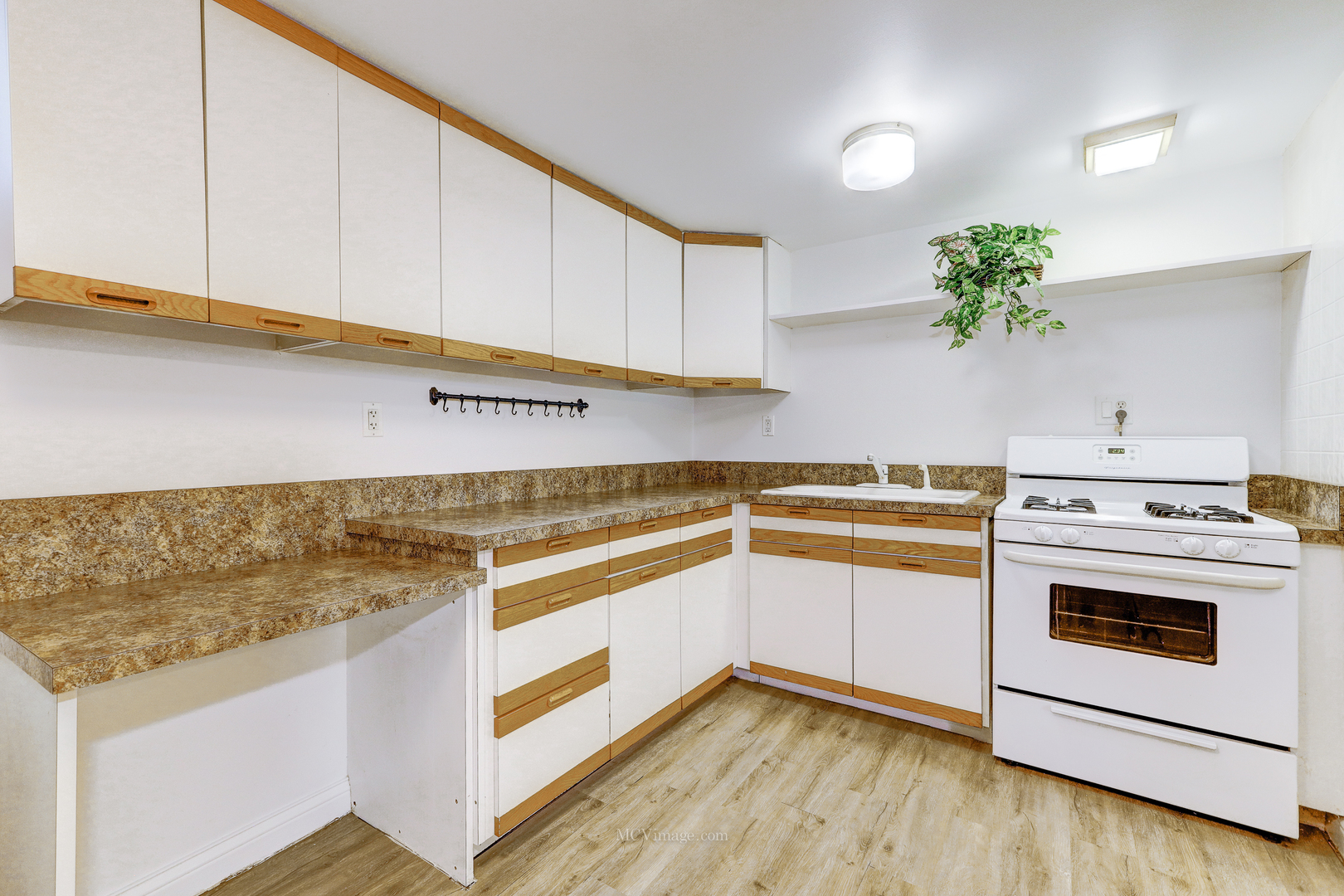 512 Porter Street, Unit B Lemont, IL 60439 - Photo 4 of 22 a kitchen with stainless steel appliances white cabinets and a counter top space