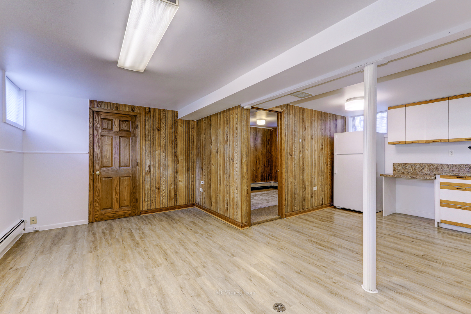 512 Porter Street, Unit B Lemont, IL 60439 - Photo 8 of 22 a view of an empty room with wooden floor and a window