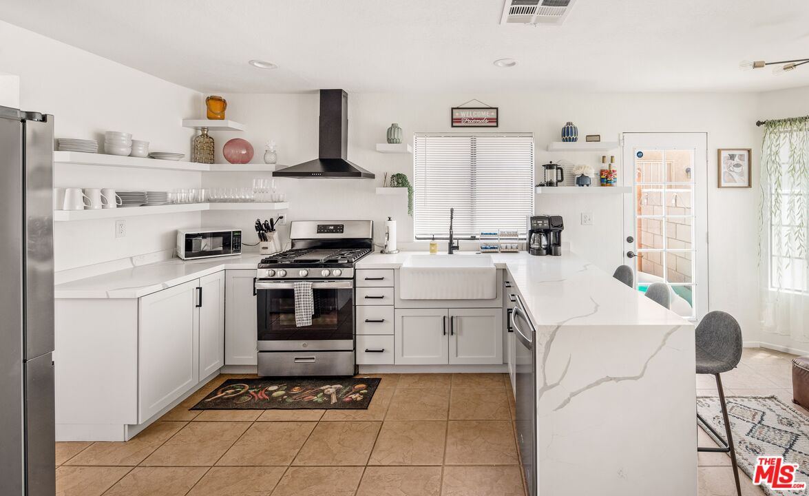 45808 Sutter Creek Road Indio, CA 92201 - Photo 13 of 33 a kitchen with cabinets and appliances