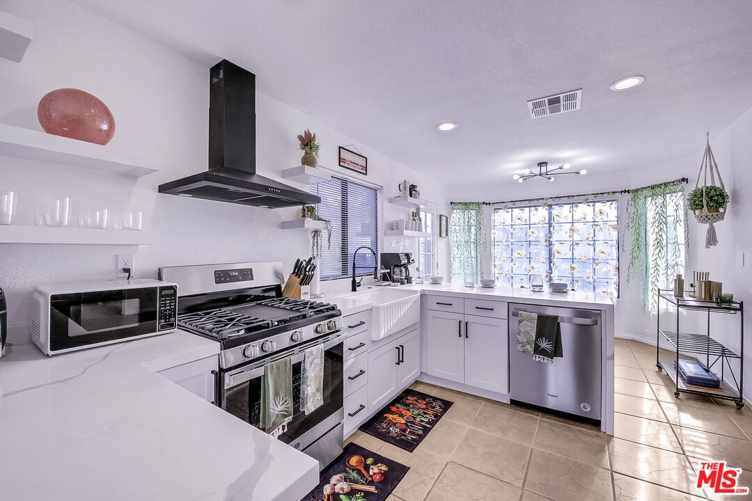45808 Sutter Creek Road Indio, CA 92201 - Photo 14 of 33 a kitchen with a stove and a sink