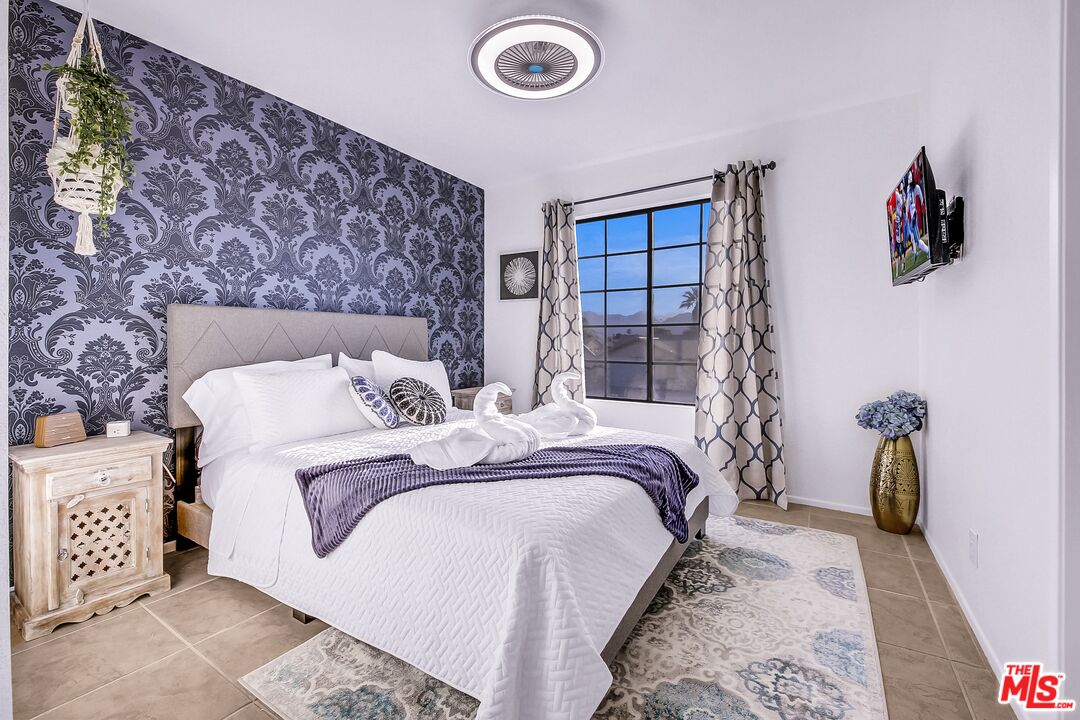 45808 Sutter Creek Road Indio, CA 92201 - Photo 22 of 33 a bed sitting in a bedroom next to a window