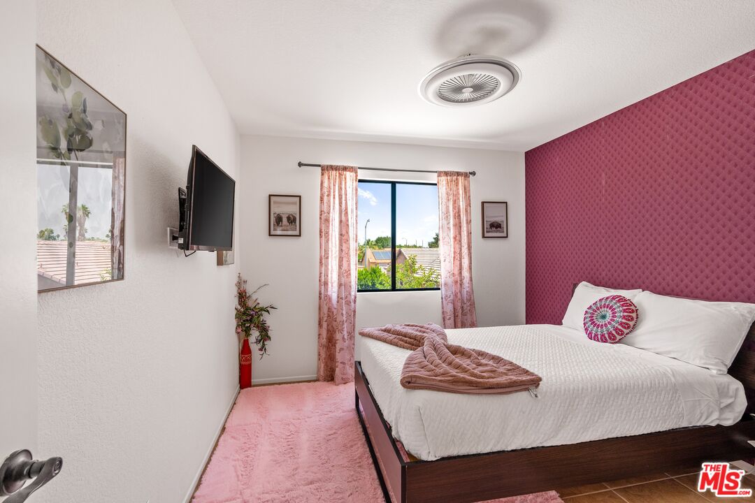 45808 Sutter Creek Road Indio, CA 92201 - Photo 23 of 33 a bedroom with a bed and a flat screen tv