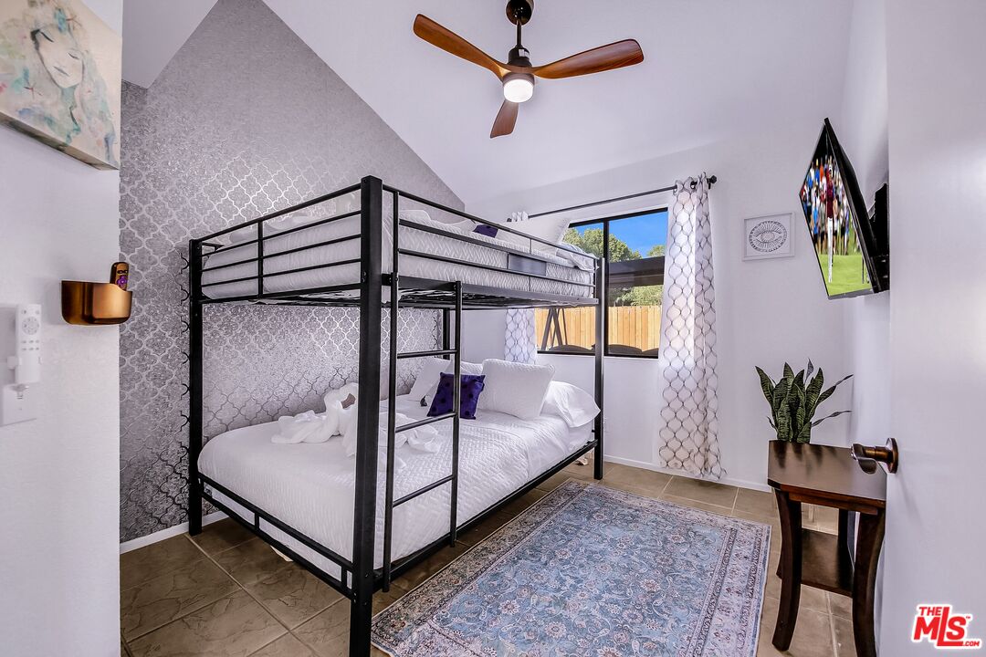 45808 Sutter Creek Road Indio, CA 92201 - Photo 26 of 33 a bedroom with a bed a window and potted plant