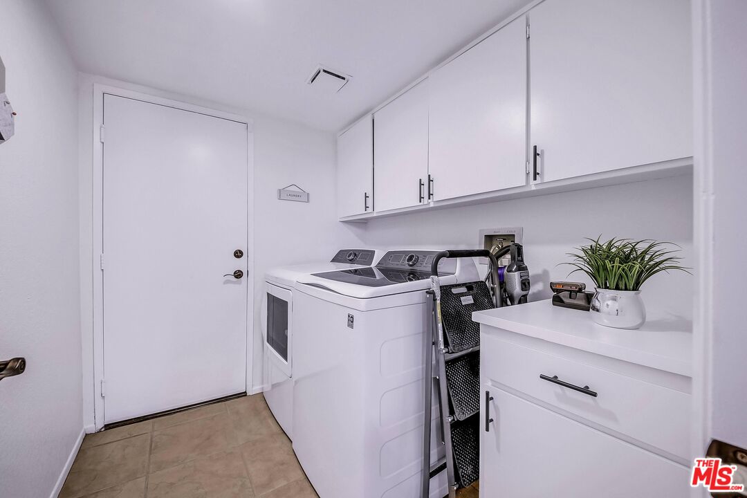 45808 Sutter Creek Road Indio, CA 92201 - Photo 29 of 33 a utility room with cabinets washer and dryer