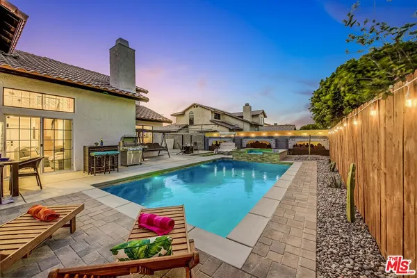 swimming pool view with two chairs