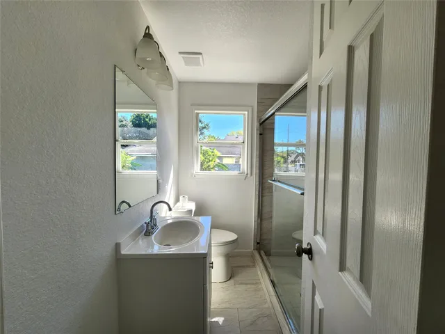 a bathroom with a sink toilet and shower