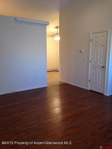 300 Columbine Drive Rifle, CO 81650 - Photo 5 of 8 an empty room with wooden floor and windows