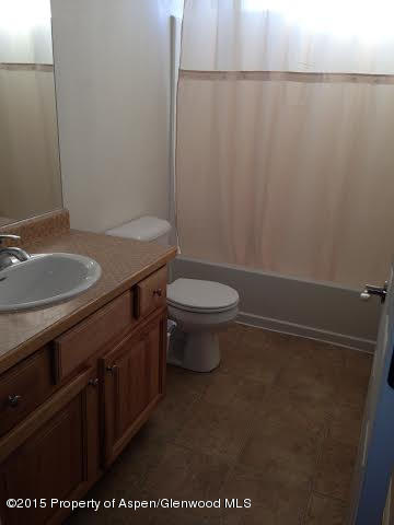 300 Columbine Drive Rifle, CO 81650 - Photo 7 of 8 a bathroom with a granite countertop sink and a toilet