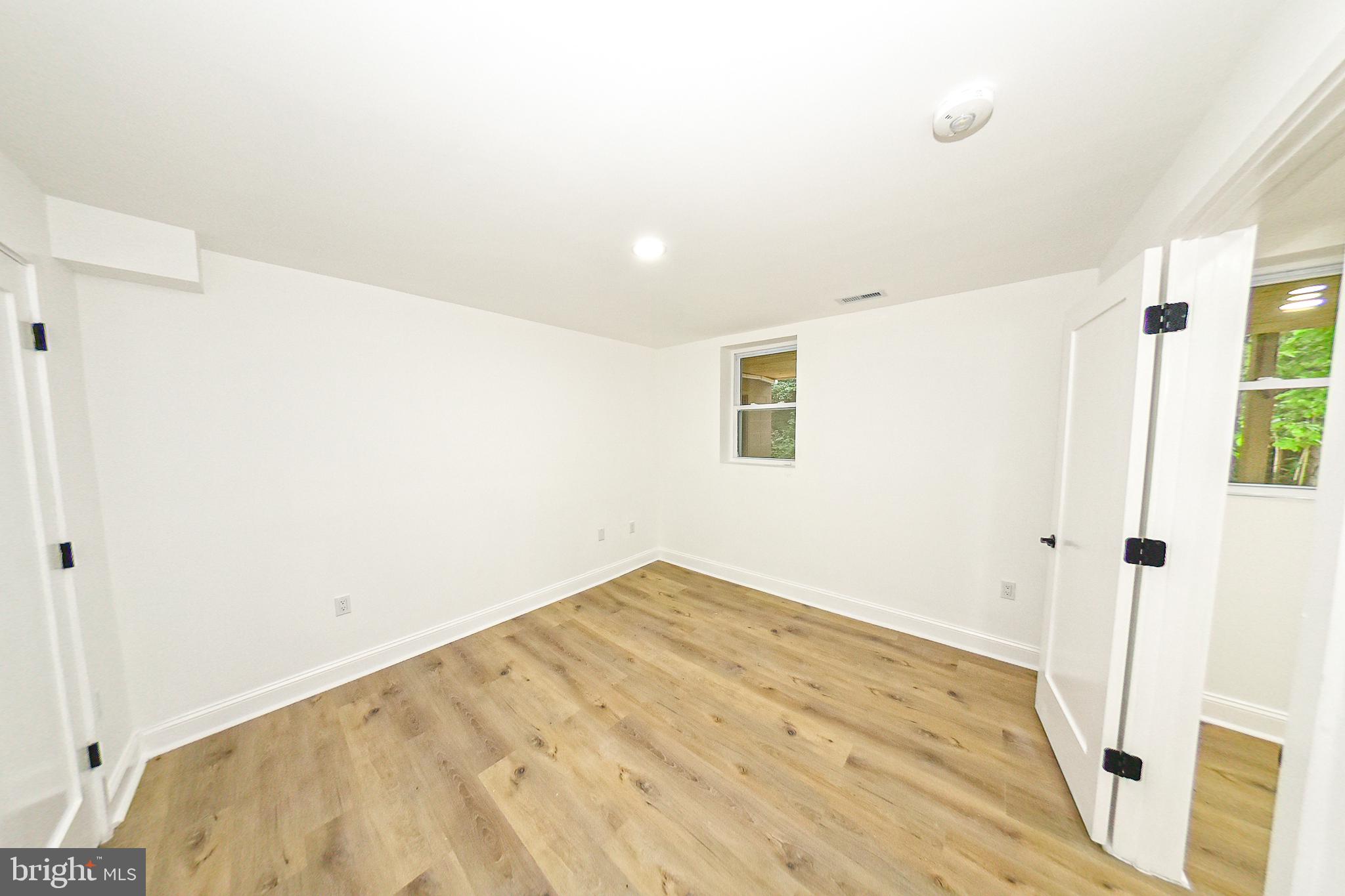 3704 Suitland Road Southeast Washington, DC 20020 - Photo 38 of 70 a view of a room with wooden floor and white walls