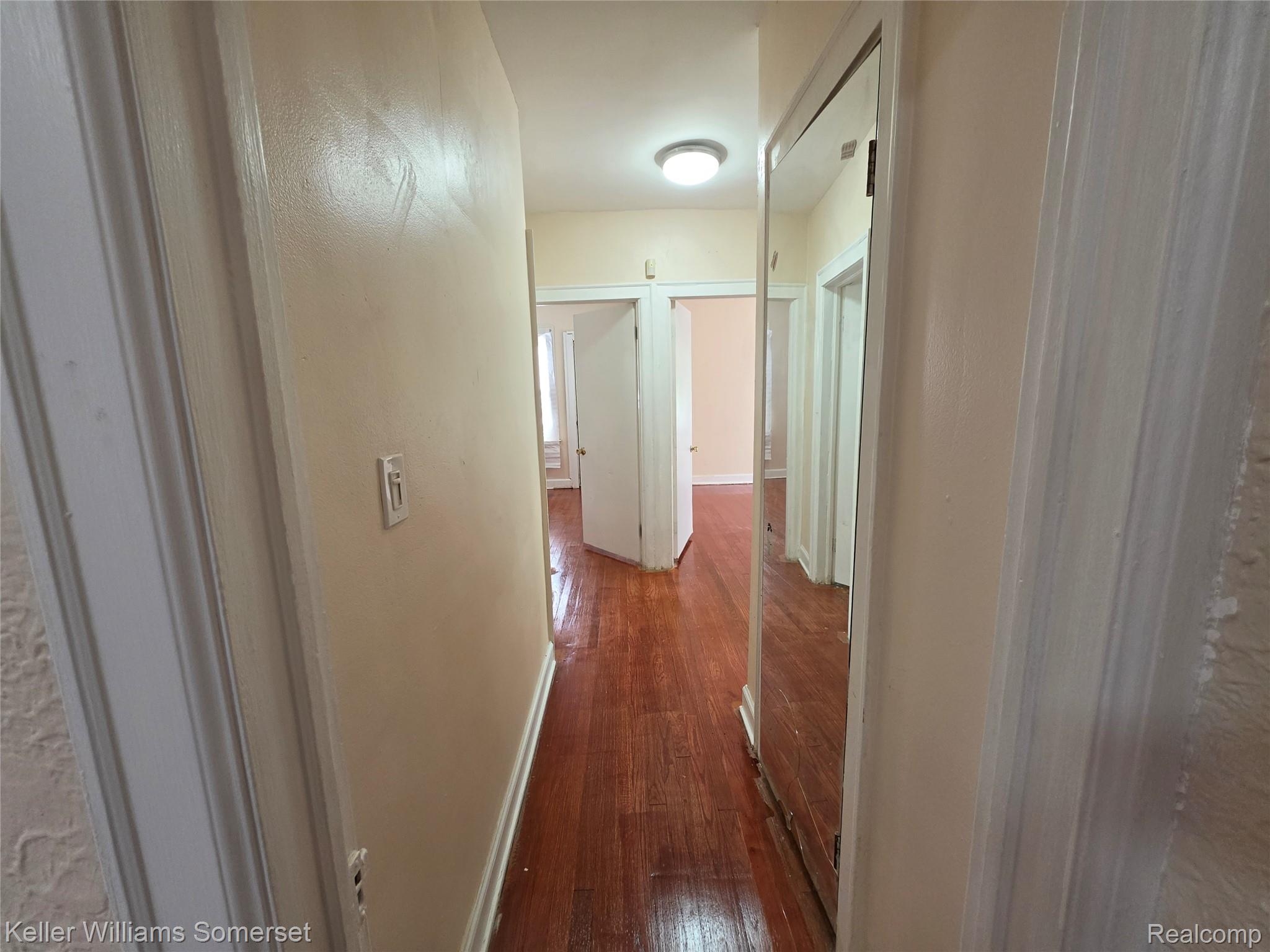 12609 Santa Rosa Drive Detroit, MI 48238 - Photo 6 of 11 Hallway featuring wood-finish flooring, light-toned walls, and a flush mount ceiling light