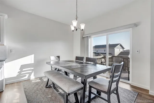 a view of a dining room with furniture and a chandelier
