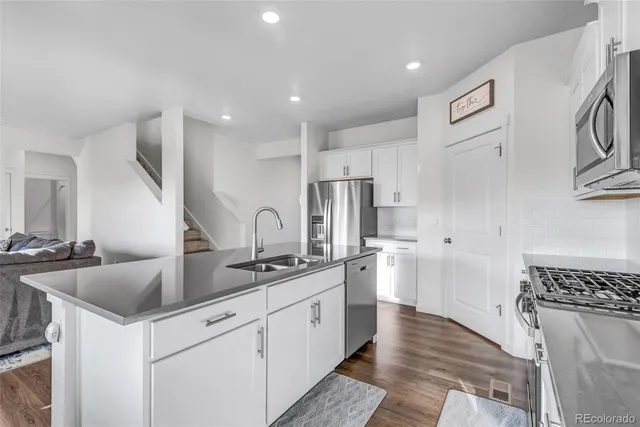 a kitchen with stainless steel appliances granite countertop a sink and cabinets