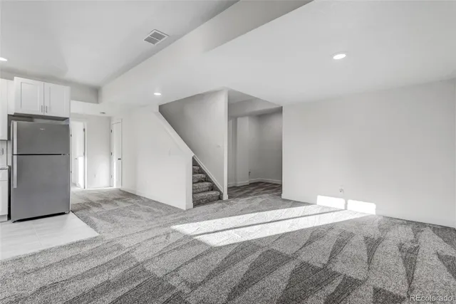 a kitchen with a refrigerator and a sink
