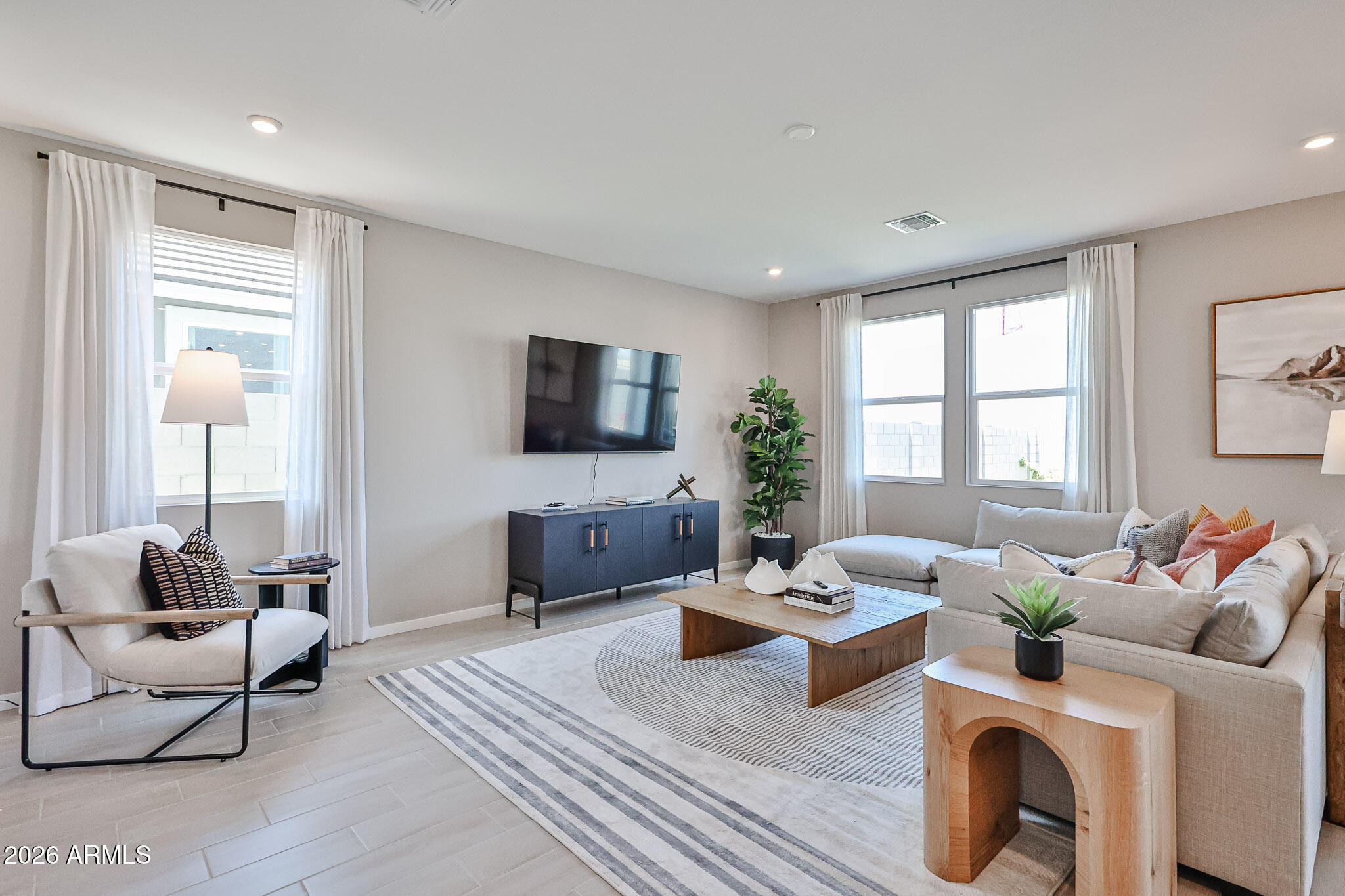 12466 North 305th Avenue Buckeye, AZ 85396 - Photo 12 of 51 a living room with furniture a flat screen tv and a large window
