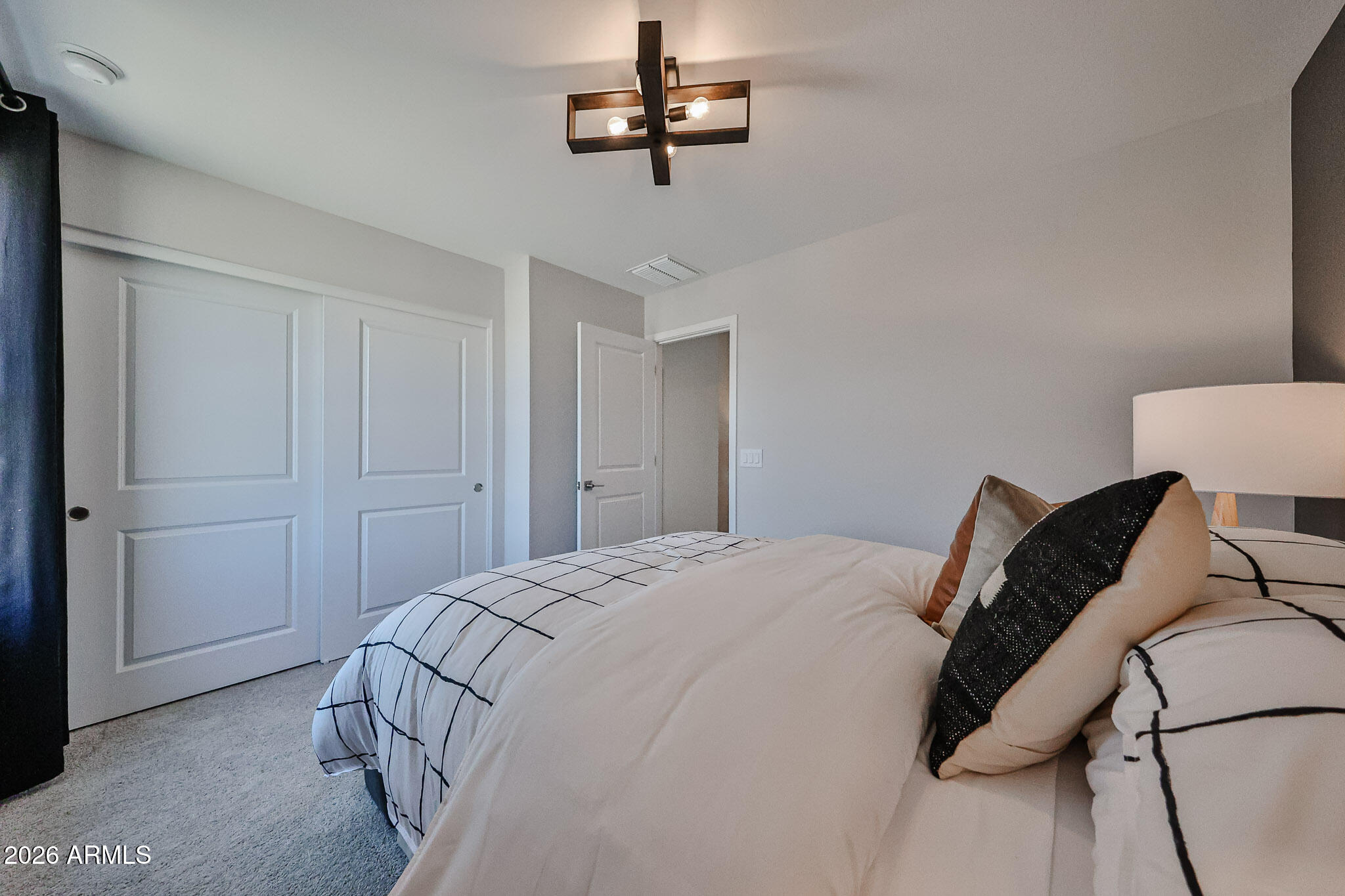 12466 North 305th Avenue Buckeye, AZ 85396 - Photo 19 of 51 a bedroom with a bed and a lamp