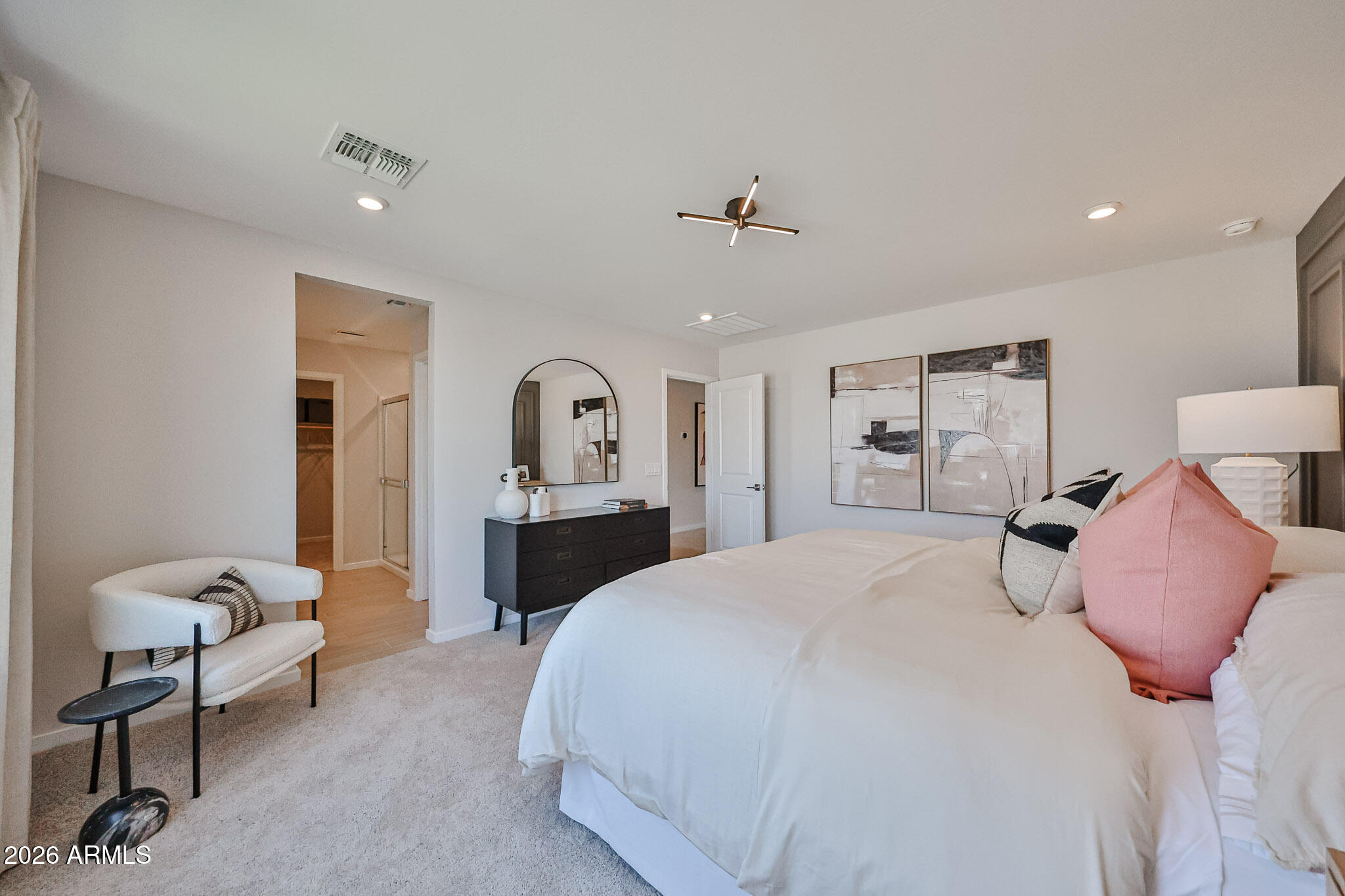 12466 North 305th Avenue Buckeye, AZ 85396 - Photo 20 of 51 a spacious bedroom with a bed and a chandelier