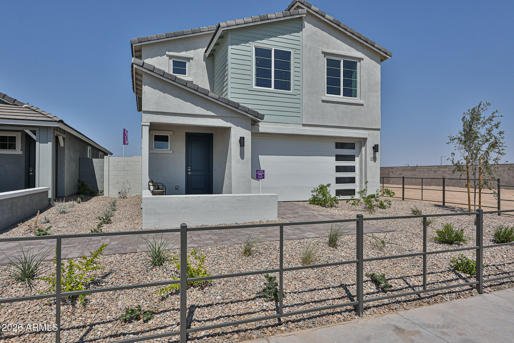 12466 North 305th Avenue Buckeye, AZ 85396 - Photo 2 of 51 a front view of a house with trees