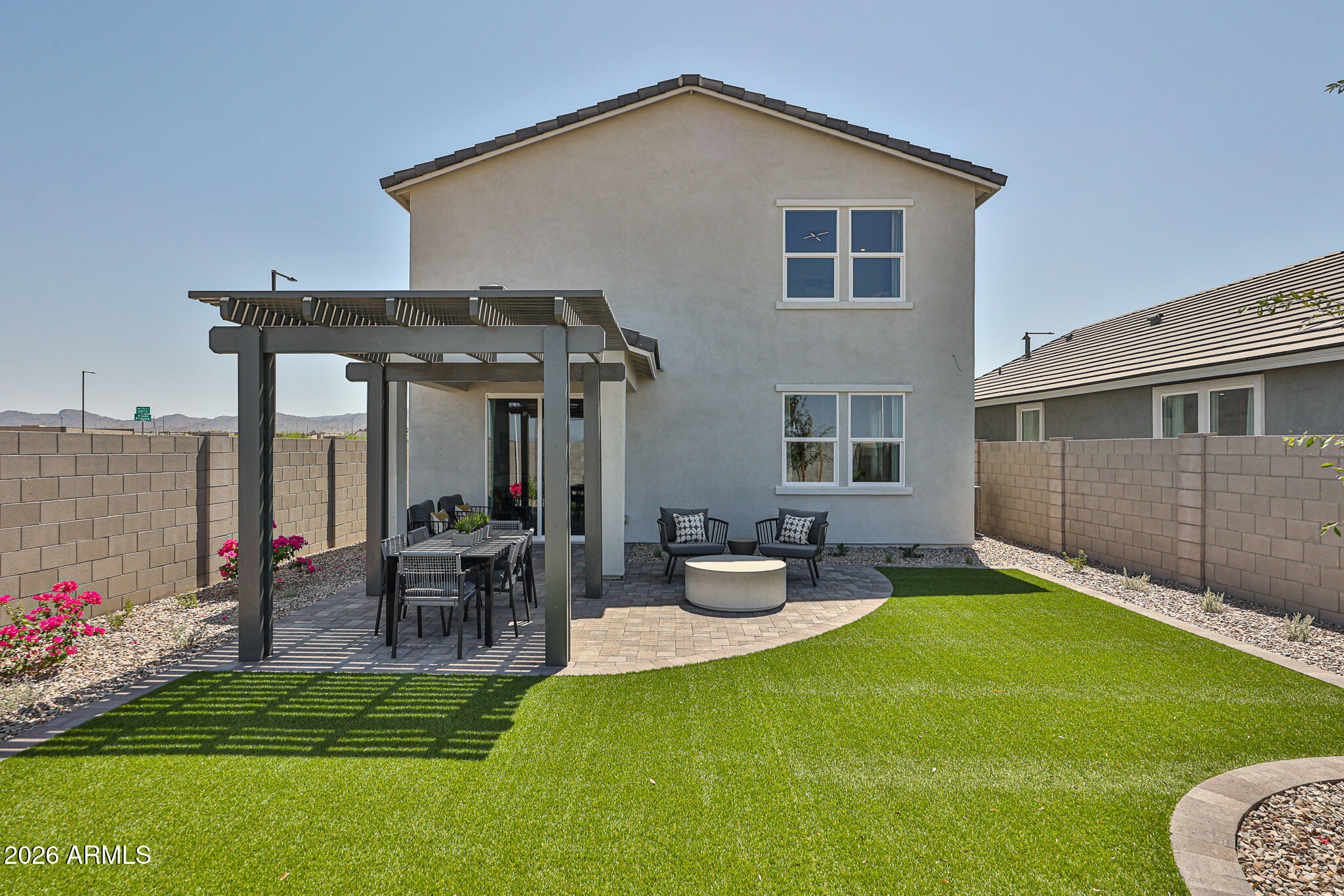 12466 North 305th Avenue Buckeye, AZ 85396 - Photo 21 of 51 a view of a house with backyard sitting area and garden