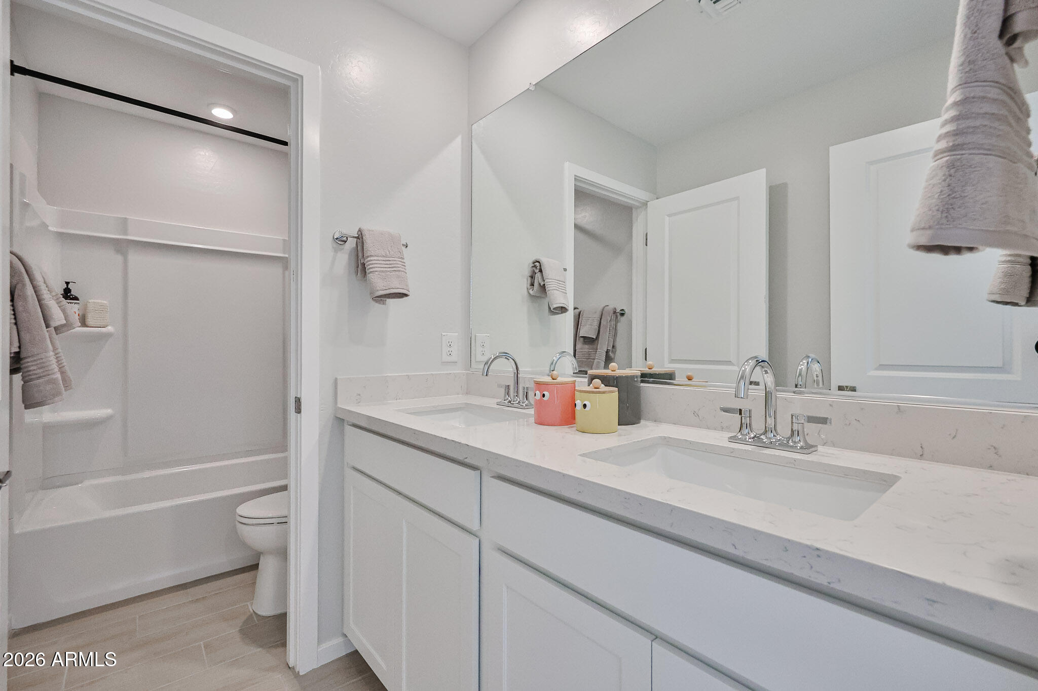 12466 North 305th Avenue Buckeye, AZ 85396 - Photo 24 of 51 a bathroom with a granite countertop sink a toilet and a bathtub