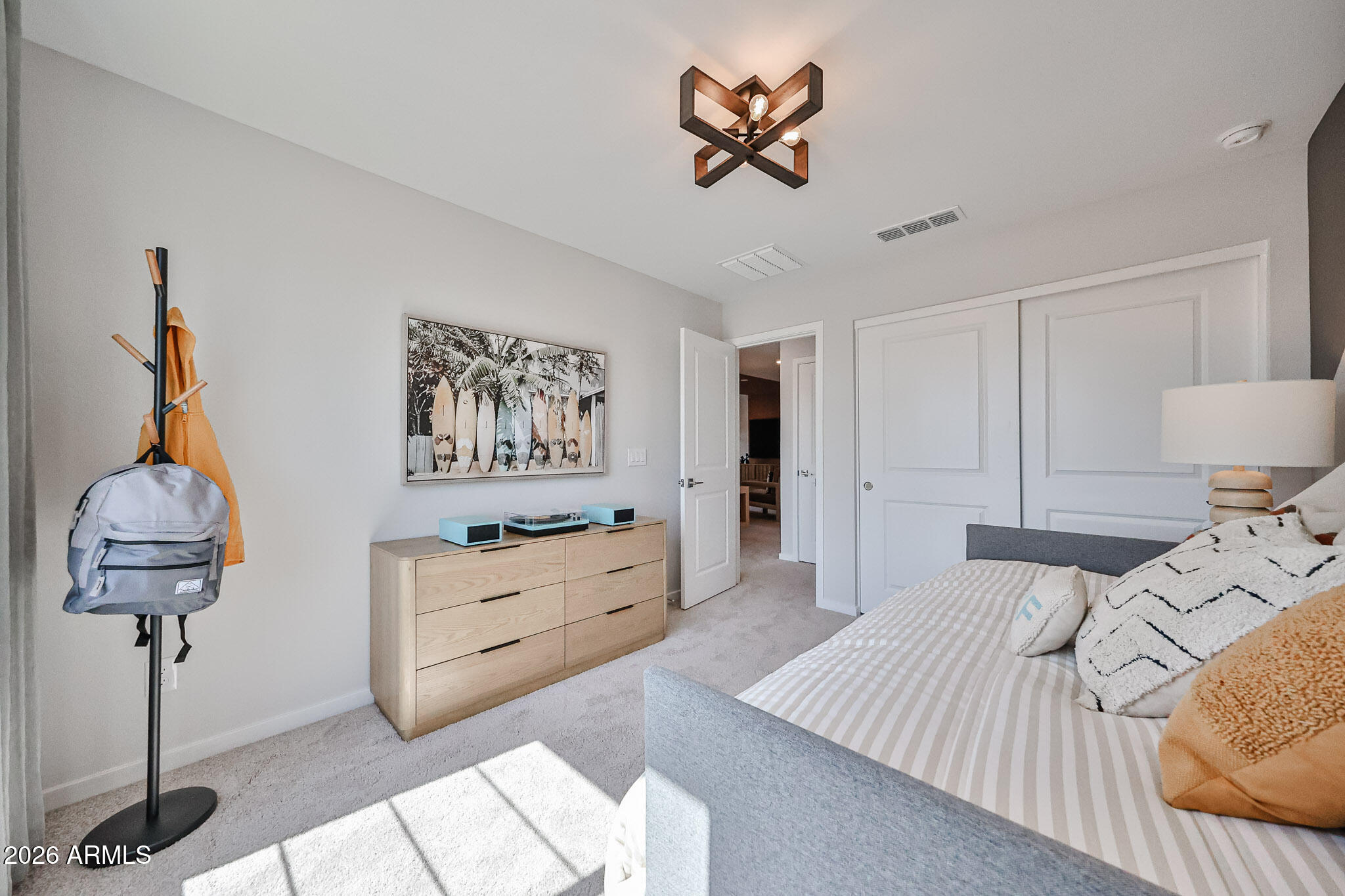 12466 North 305th Avenue Buckeye, AZ 85396 - Photo 25 of 51 a bedroom with a bed and a chandelier