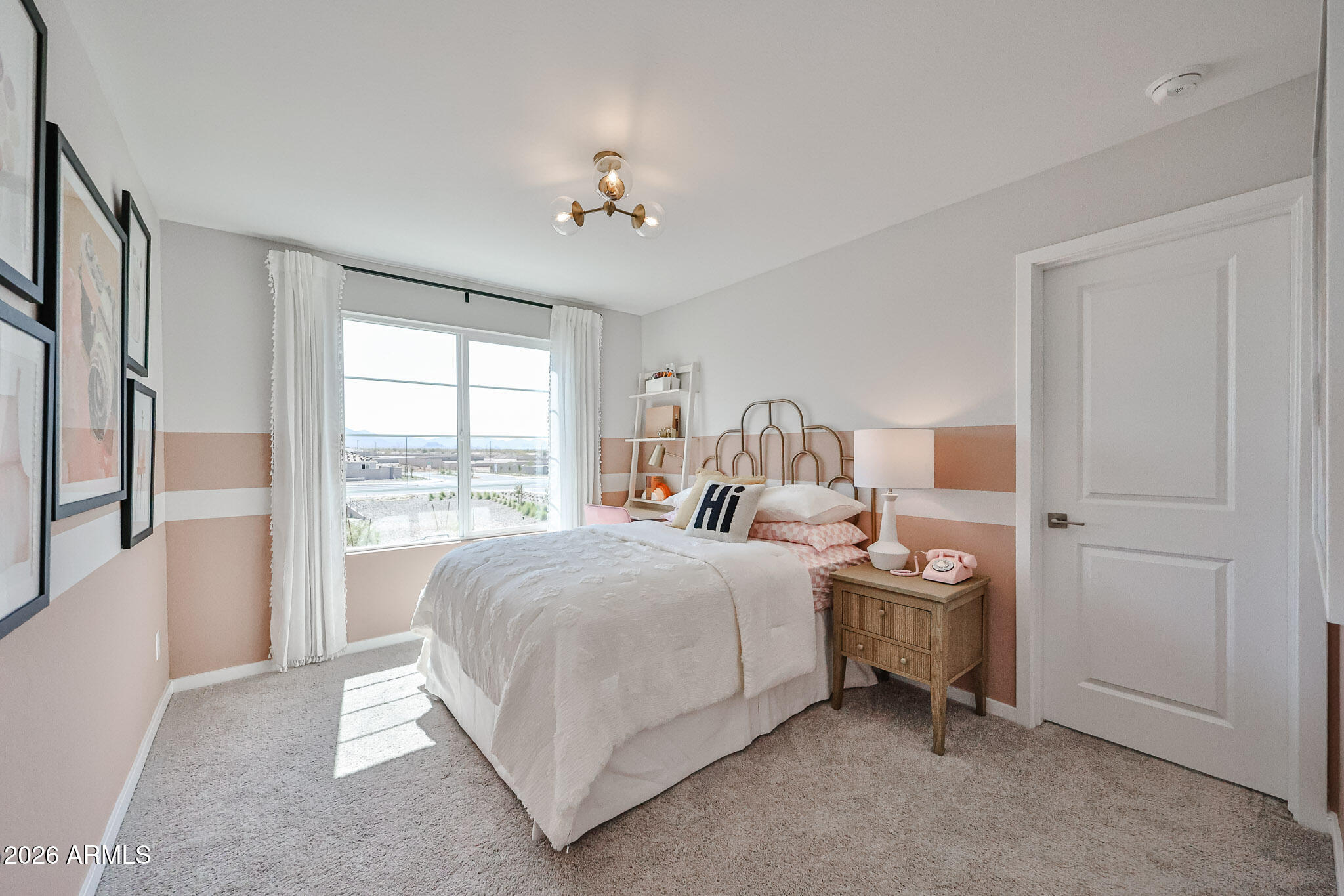 12466 North 305th Avenue Buckeye, AZ 85396 - Photo 28 of 51 a bedroom with a bed and a chandelier