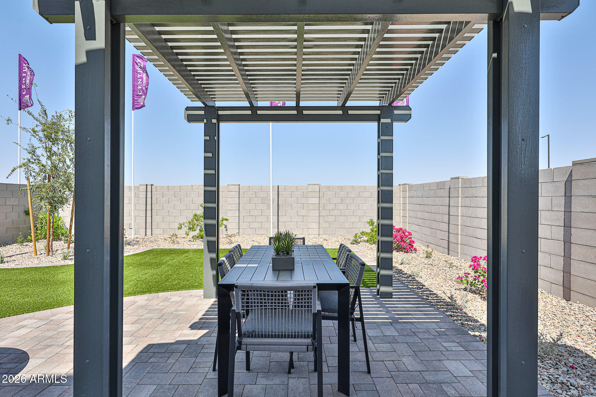 12466 North 305th Avenue Buckeye, AZ 85396 - Photo 31 of 51 a view of a patio with a table and chairs and potted plants