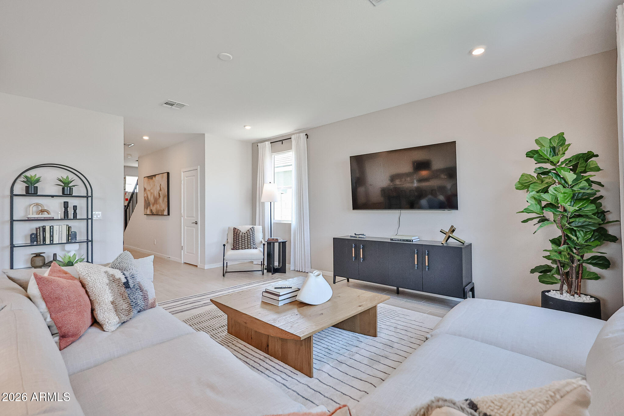 12466 North 305th Avenue Buckeye, AZ 85396 - Photo 39 of 51 a living room with furniture a flat screen tv and a potted plant