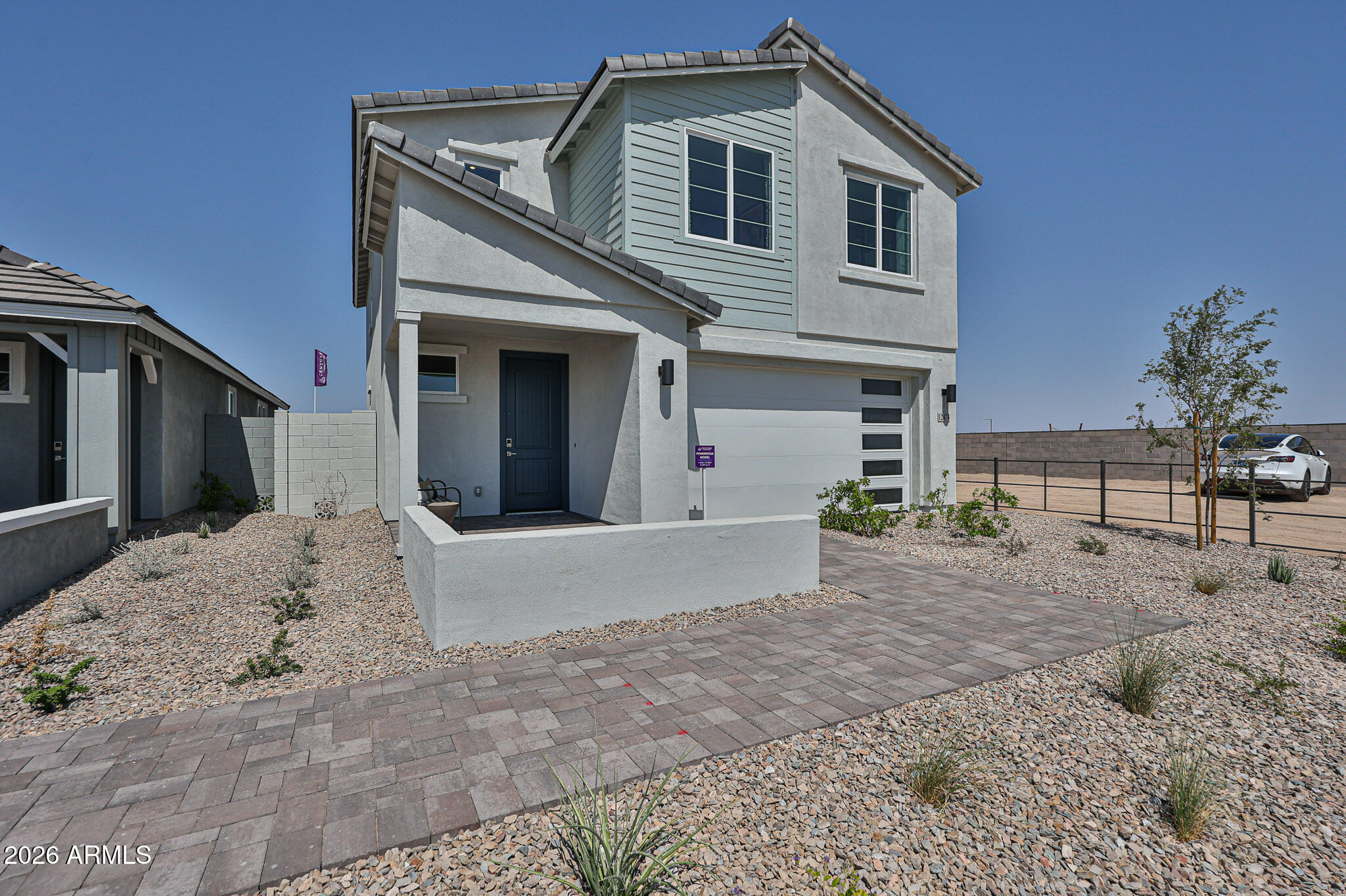 12466 North 305th Avenue Buckeye, AZ 85396 - Photo 5 of 51 a front view of a house with a yard