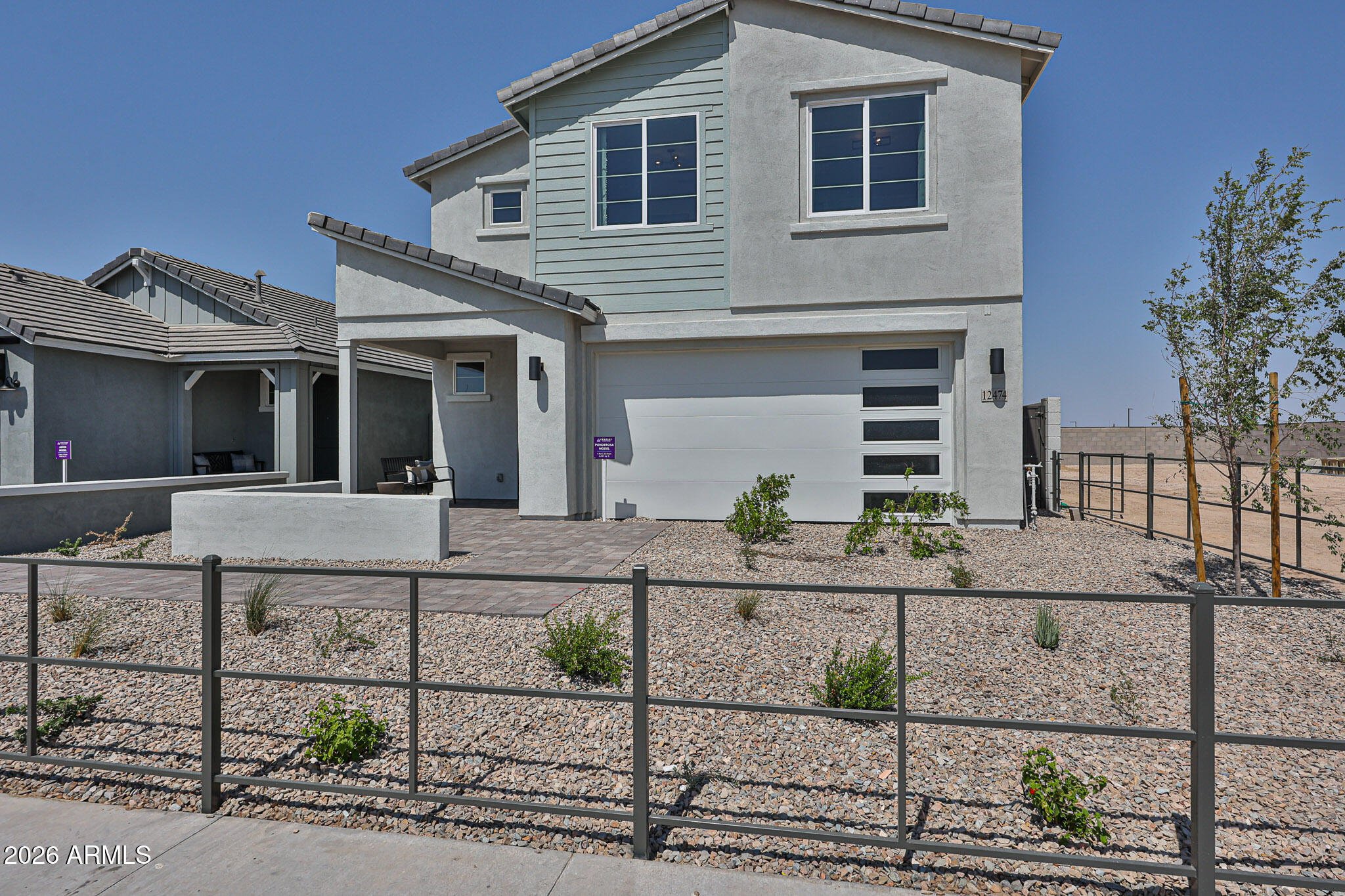 12466 North 305th Avenue Buckeye, AZ 85396 - Photo 8 of 51 a view of a white house next to a yard