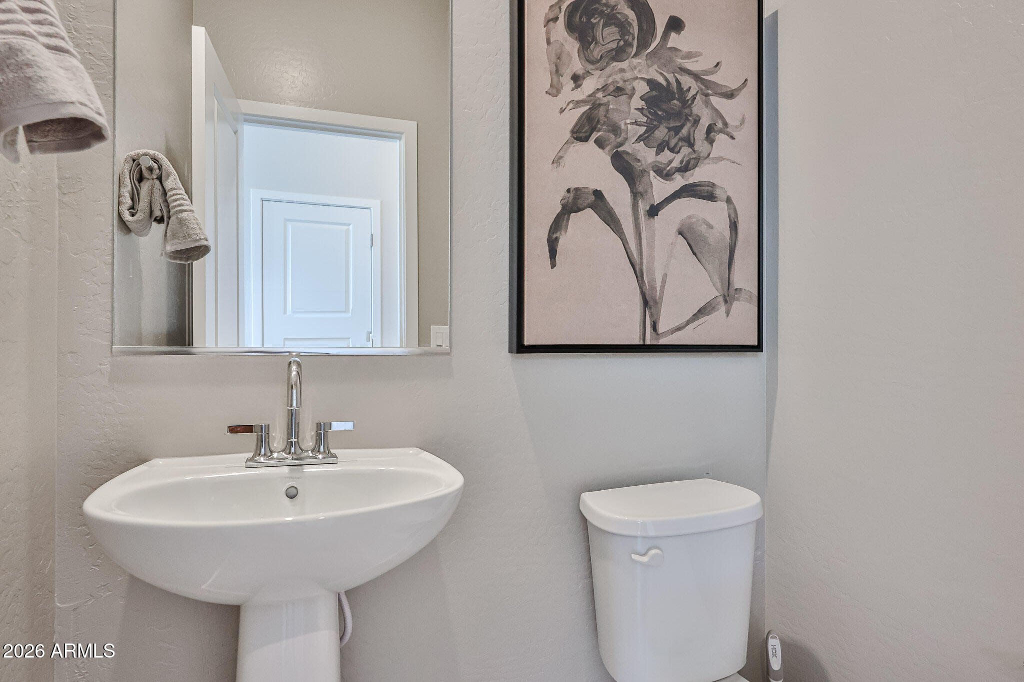 12466 North 305th Avenue Buckeye, AZ 85396 - Photo 10 of 51 a bathroom with a toilet sink and mirror