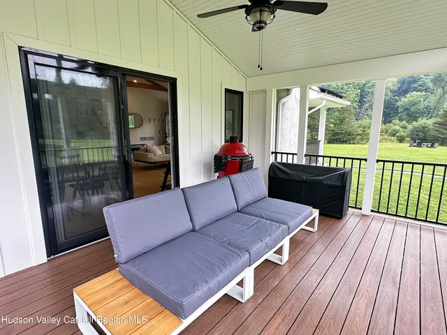 a living room with furniture and a floor to ceiling window