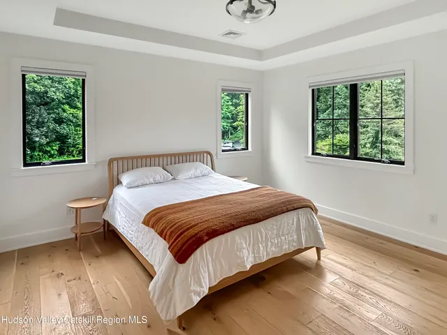 a bedroom with a bed lamp and window