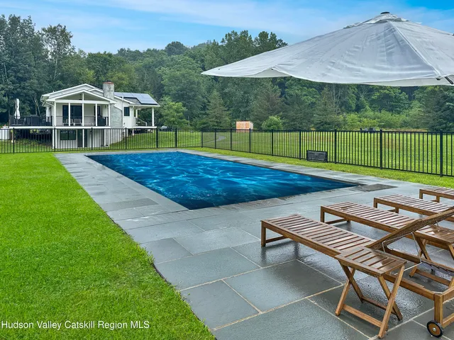 a view of a house with backyard sitting area and garden