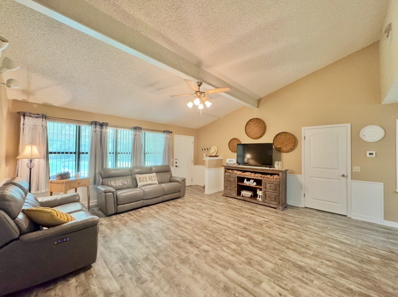 702 Pleasant Grove Road Elgin, TX 78621 - Photo 12 of 38 Living area featuring a textured ceiling, a ceiling fan, and wood finished floors