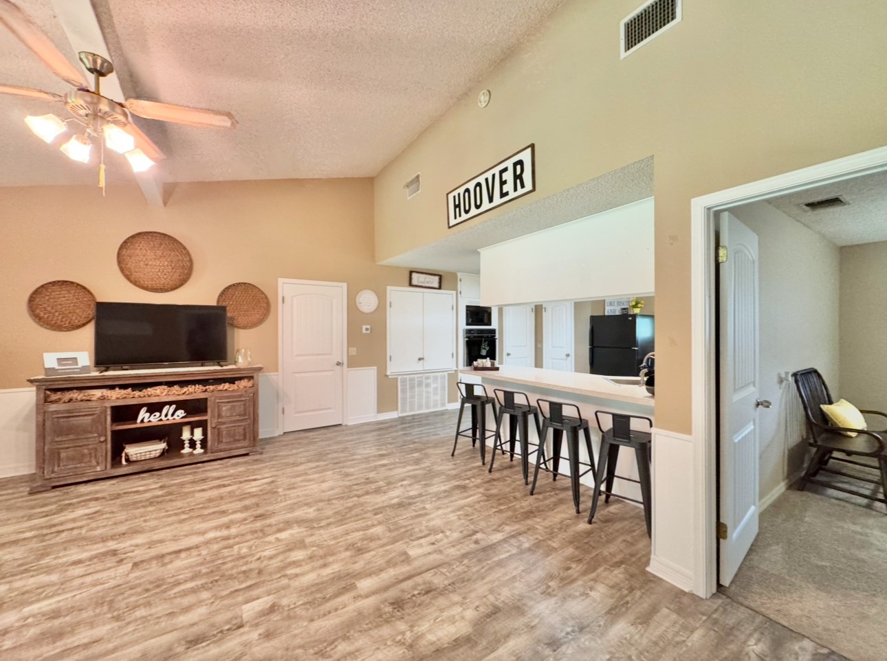 702 Pleasant Grove Road Elgin, TX 78621 - Photo 13 of 38 Living area with a textured ceiling, wood finished floors, ceiling fan, and high vaulted ceiling
