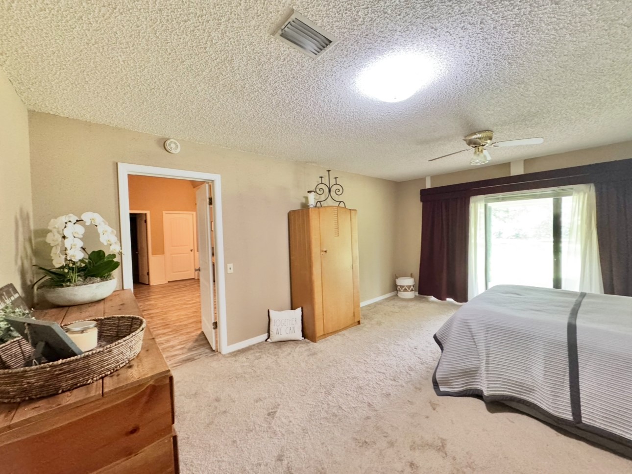 702 Pleasant Grove Road Elgin, TX 78621 - Photo 18 of 38 Carpeted bedroom featuring a textured ceiling and a ceiling fan