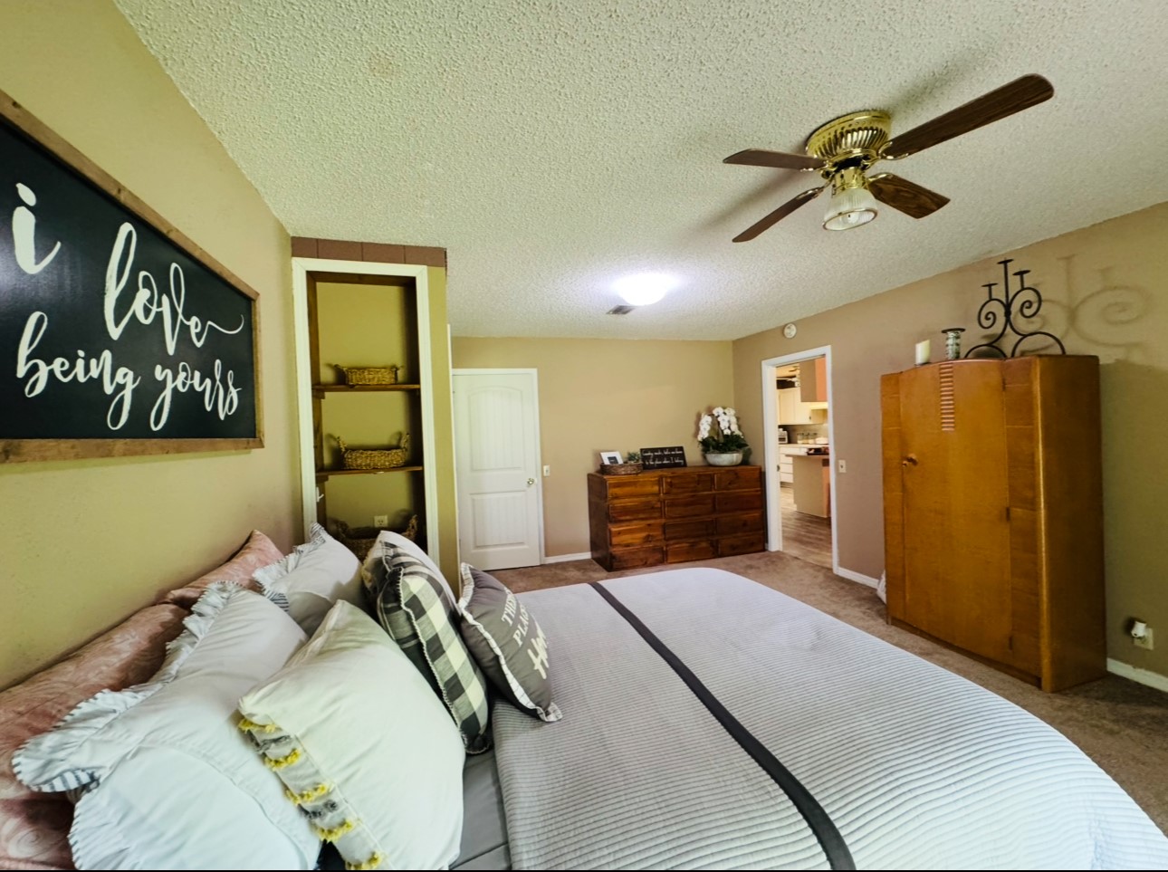 702 Pleasant Grove Road Elgin, TX 78621 - Photo 20 of 38 Carpeted bedroom featuring a textured ceiling and a ceiling fan