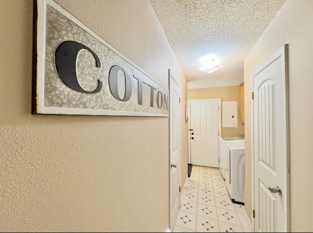 702 Pleasant Grove Road Elgin, TX 78621 - Photo 22 of 38 Laundry room with separate washer and dryer, a textured ceiling, light tile patterned floors, and cabinet space